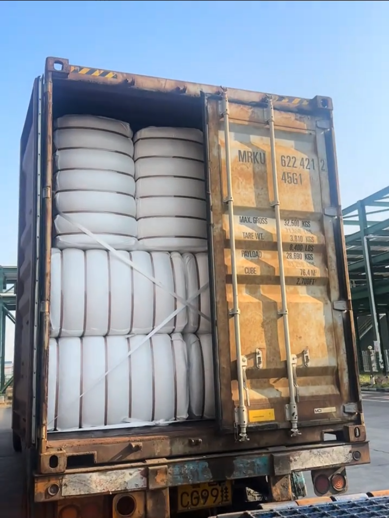 Packed fiber bales loaded into a shipping container